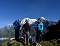 Trekkers enjoy the view of Annapurna South and Hiuchuli